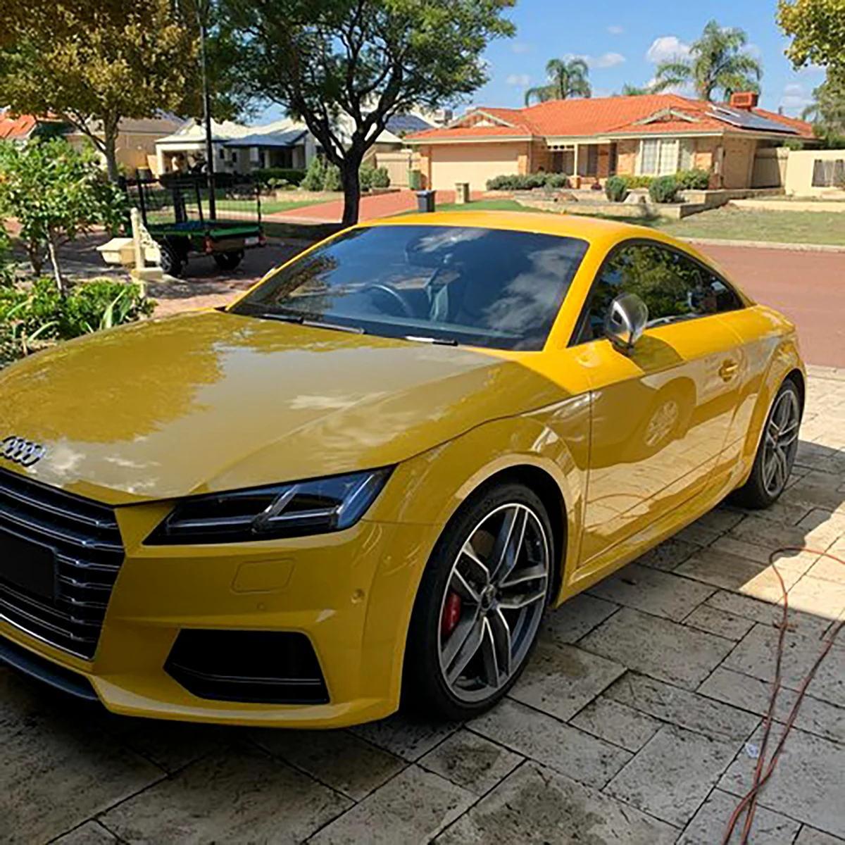 Yellow Audi on residential driveway